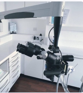 Endodontist working with operating microscope